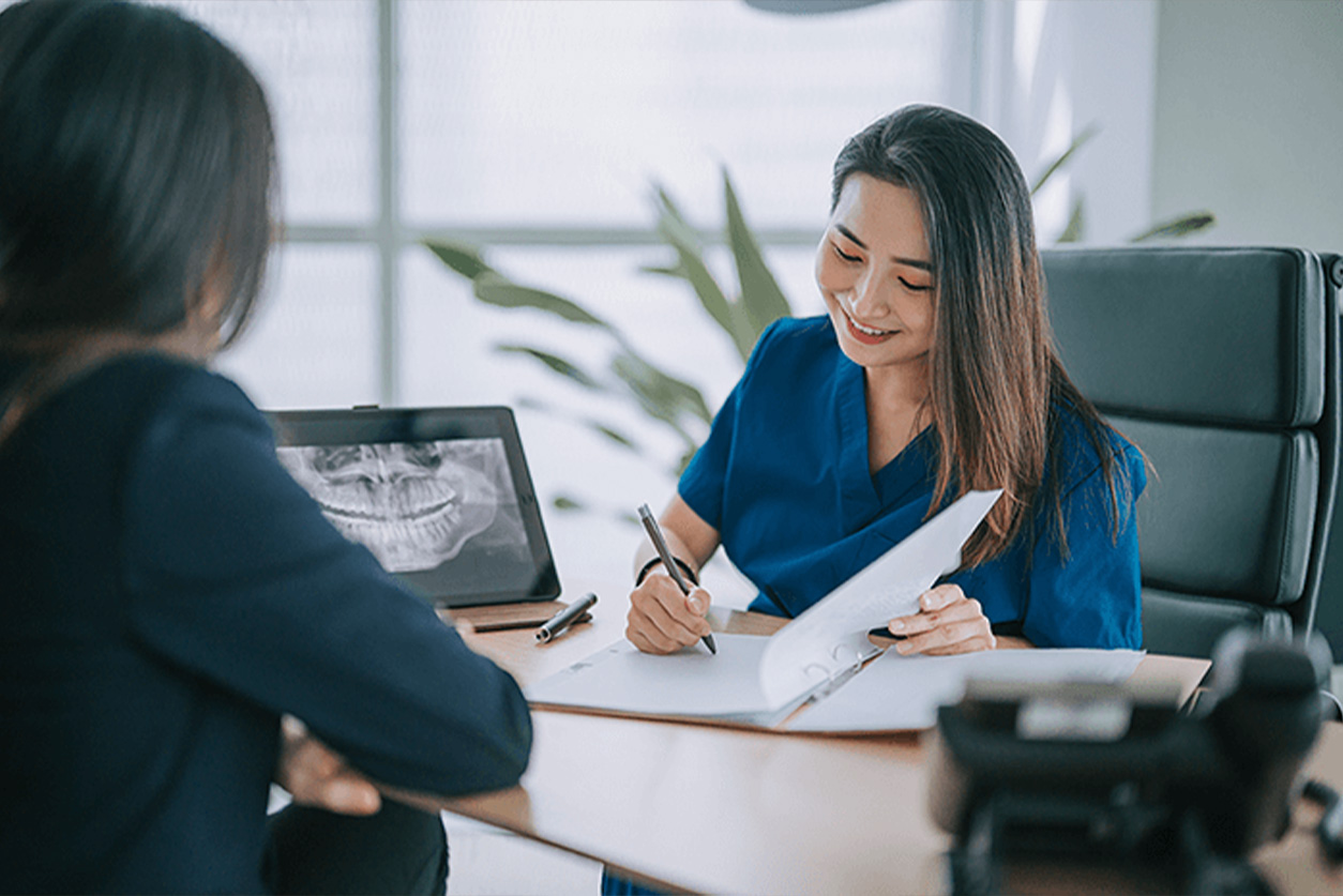 woman discussing dental bills with a patient